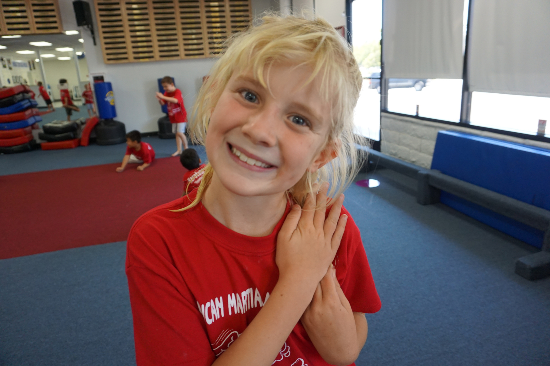A smiling student in the academy training hall